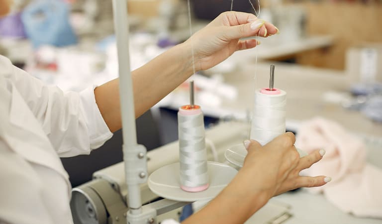Thread spools and woven ribbons on the production floor